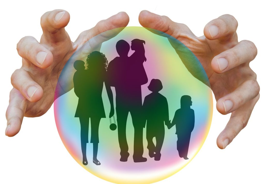 family is being protected from the outside (hands) with the help of insurance (bubble)